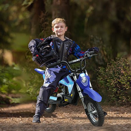 A child in a helmet seated on a blue Hiboy DK1 electric dirt bike in a park