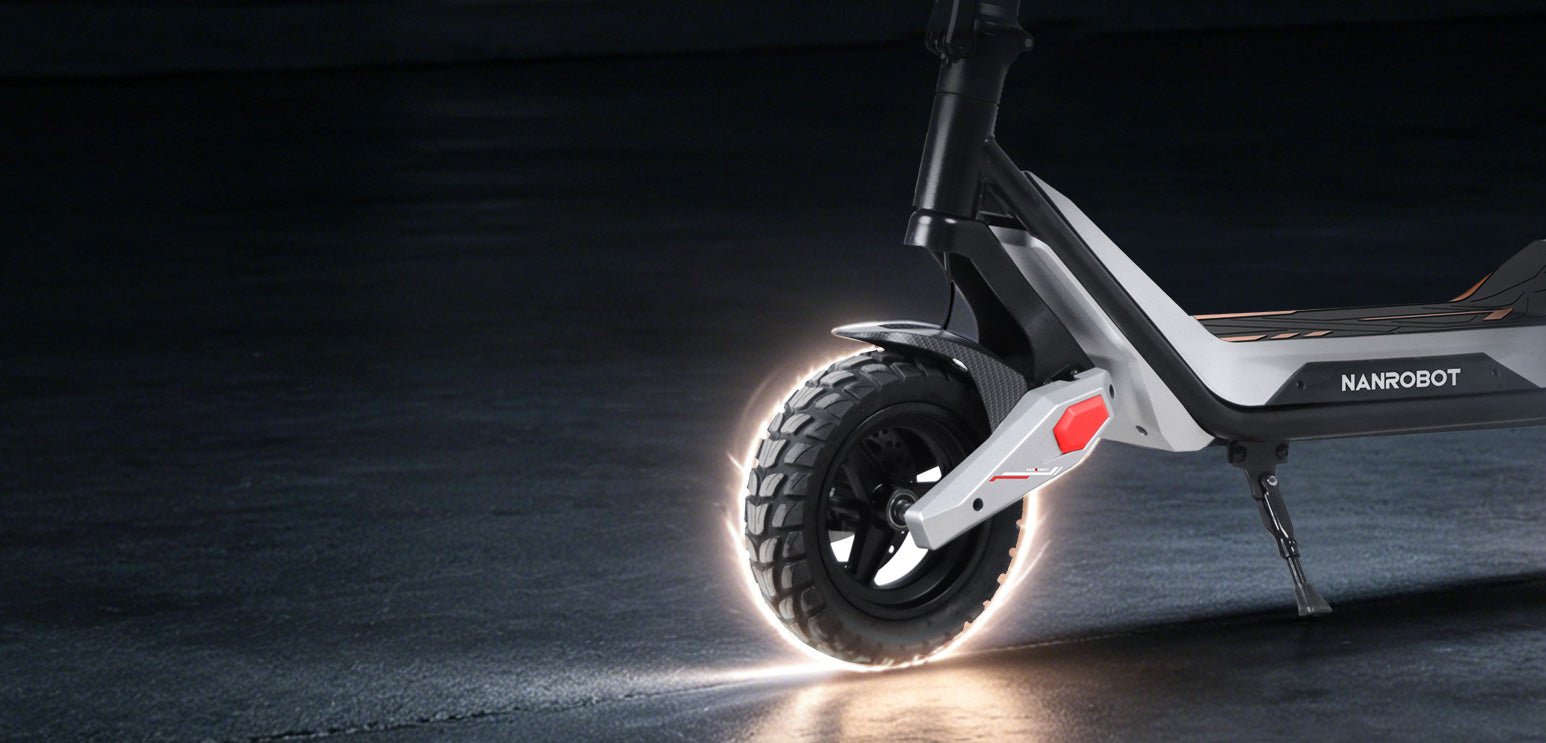 Nanrobot G3 front off-road tire glowing against dark asphalt