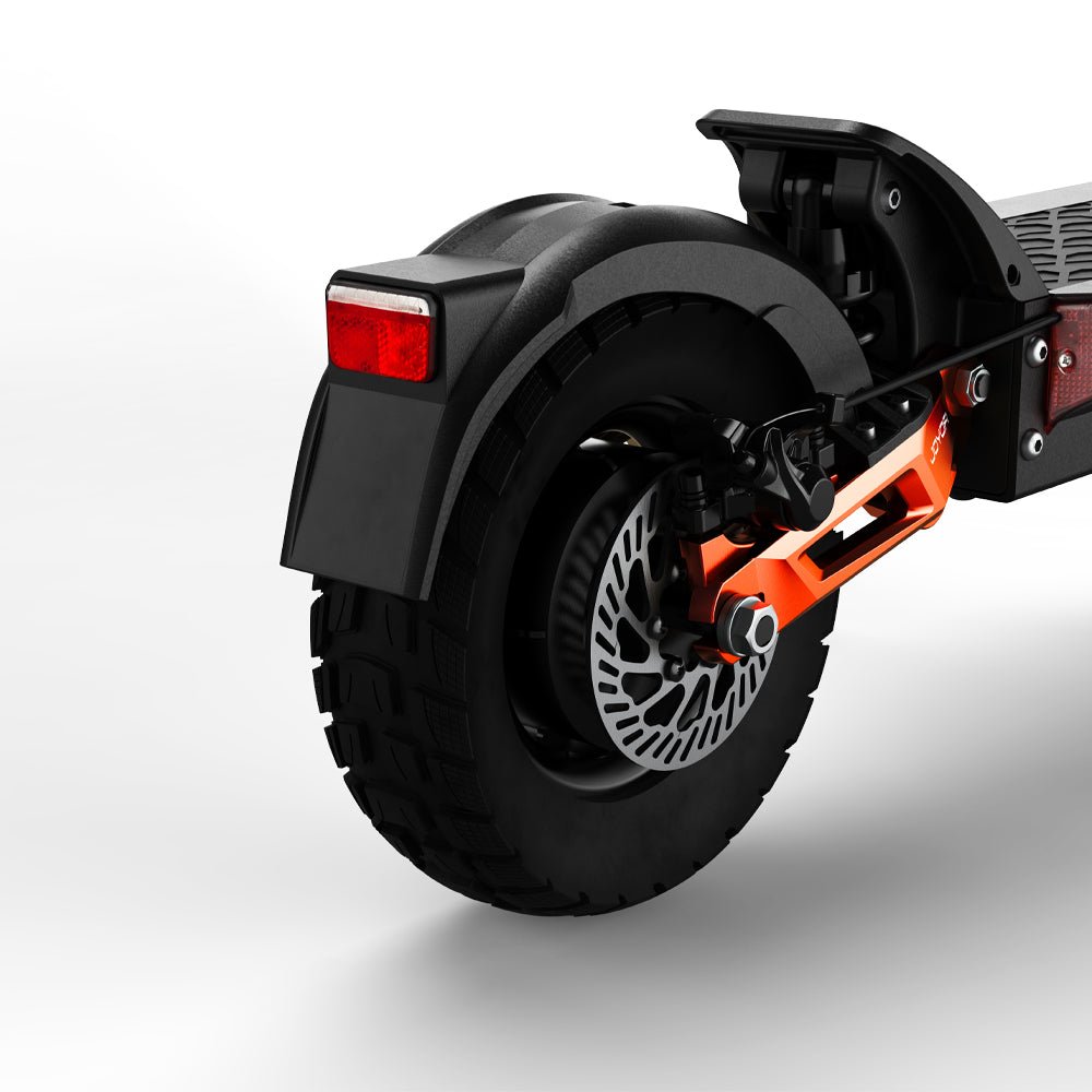 Rear wheel of the Joyor T10 showing the hydraulic disc brake, orange swingarm and off-road tread