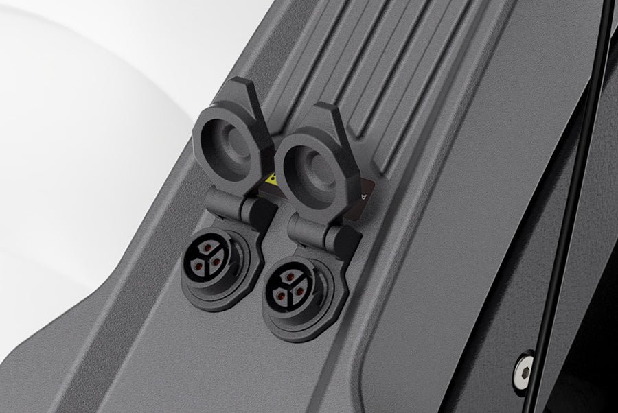 Dual charging ports of the Ausom DT2 Pro electric scooter with their covers open