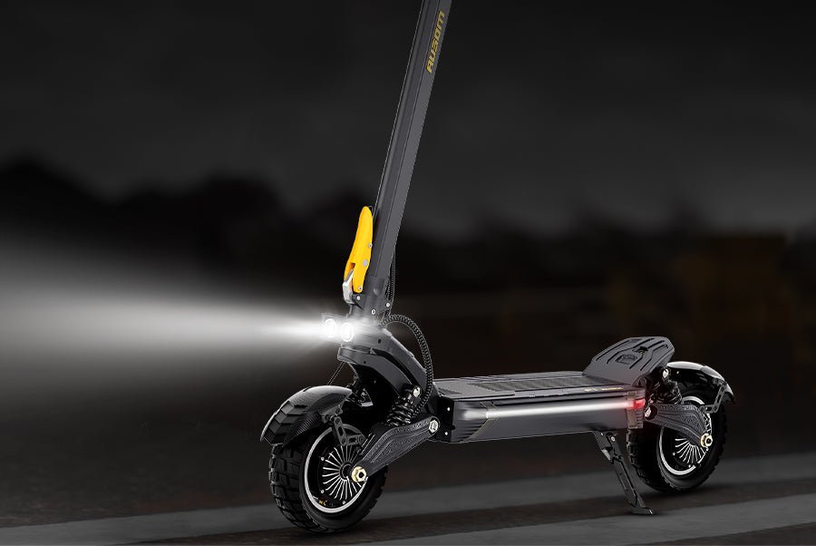Ausom F1 Max electric scooter at night with its headlight beam lighting the road ahead