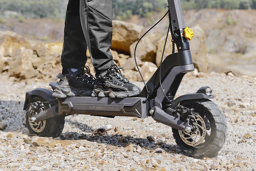 Deep-tread front tire and disc brake of the Ausom L2 Max electric scooter on gravel