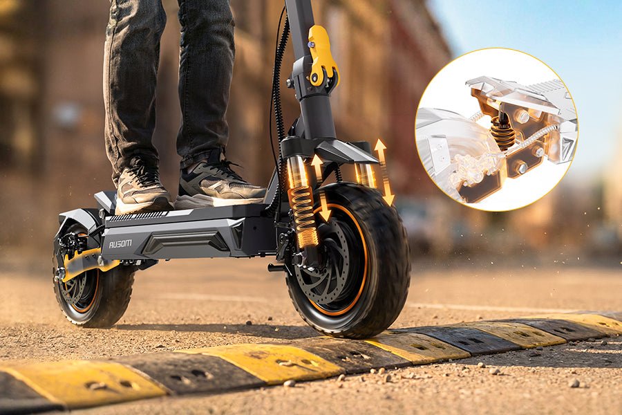 Ausom K20 Pro dual motor e-scooter riding over a speed bump, with an inset of the rear swingarm and adjustable spring