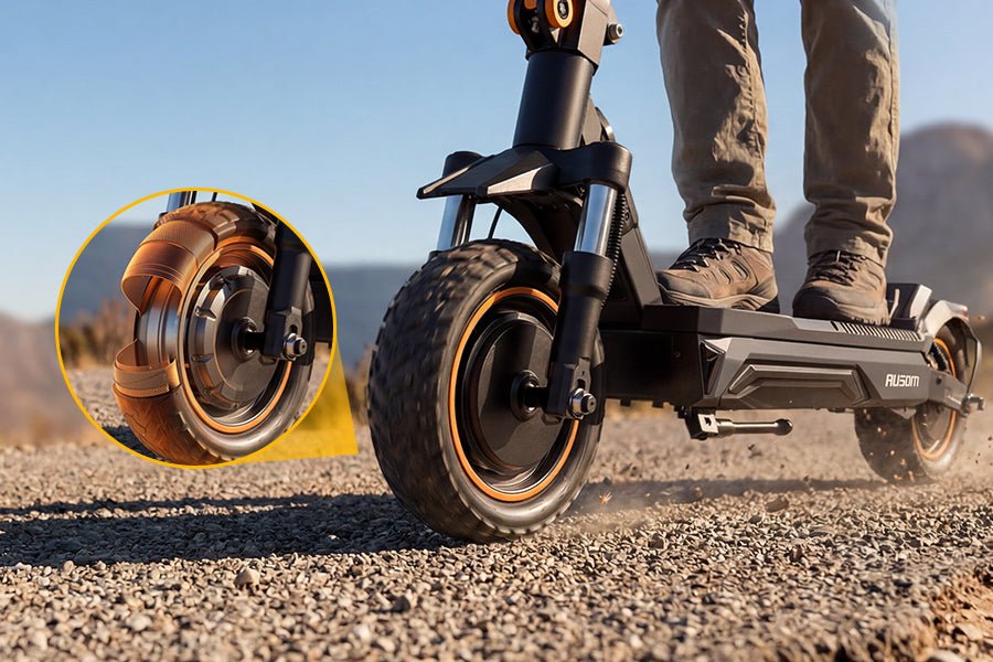 Ausom K20 Pro dual motor e-scooter front tire rolling over gravel, with an inset of the tubeless tire tread