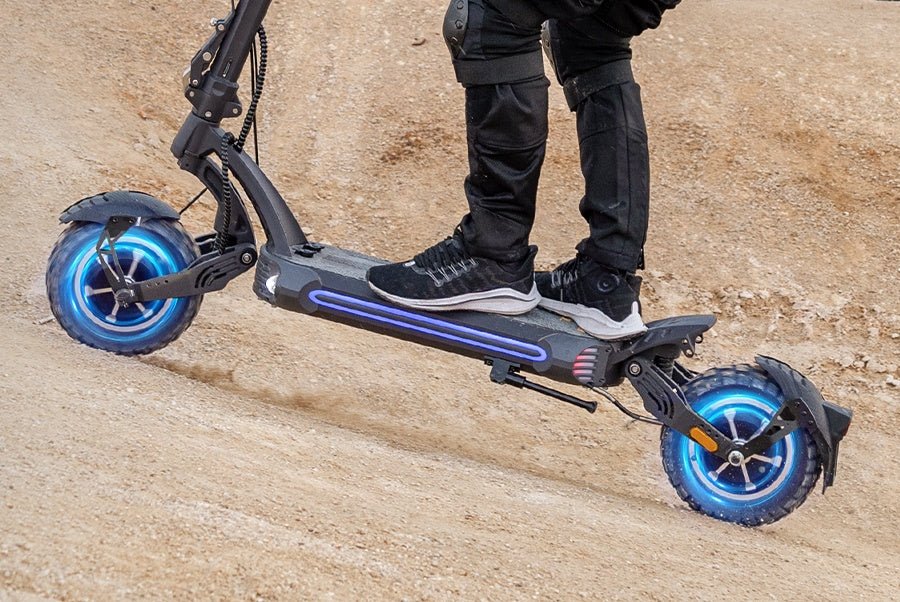 Both hub motors of the Ausom SR1 electric scooter glowing as it climbs a packed dirt slope