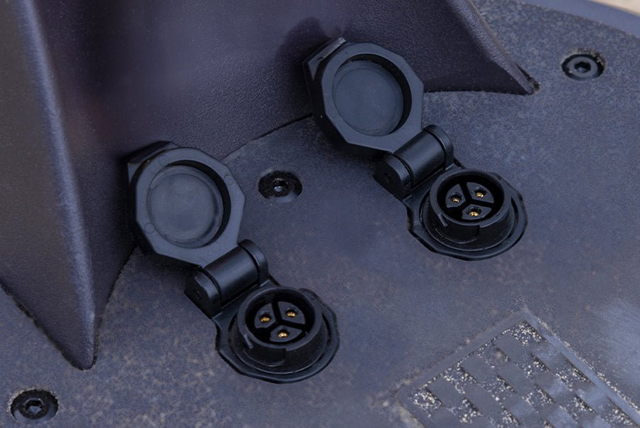 Twin charging ports of the Ausom SR1 electric scooter with their rubber covers open