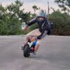 Rider leaning an INMOTION V14 PRO electric unicycle low on tarmac