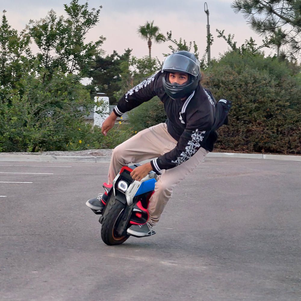 Rider leaning an INMOTION V14 PRO electric unicycle low on tarmac