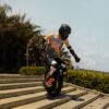 Rider taking an INMOTION P6 electric unicycle down a flight of steps