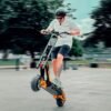 Rider on an INMOTION RS electric scooter in a skate park in daylight