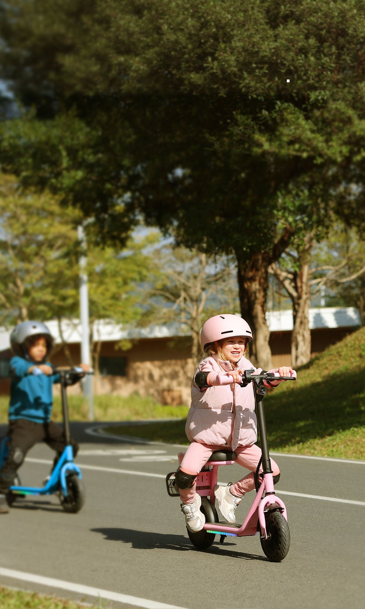 Smiling child seated on a Hiboy Q2 Lite kids electric scooter with 5 miles range and 70 minutes run time callouts