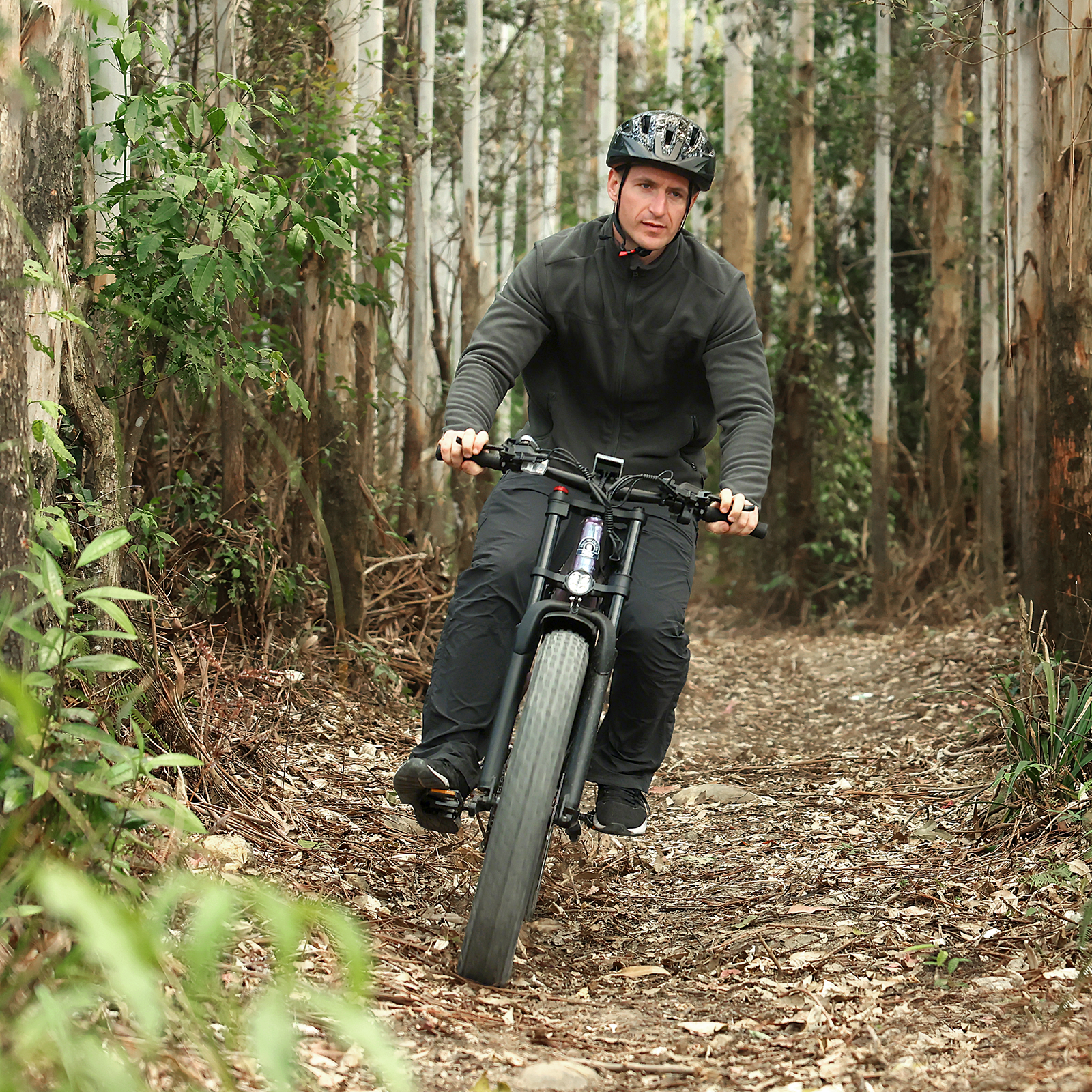 Rider on a Hiboy EX11 electric bike on a narrow forest trail