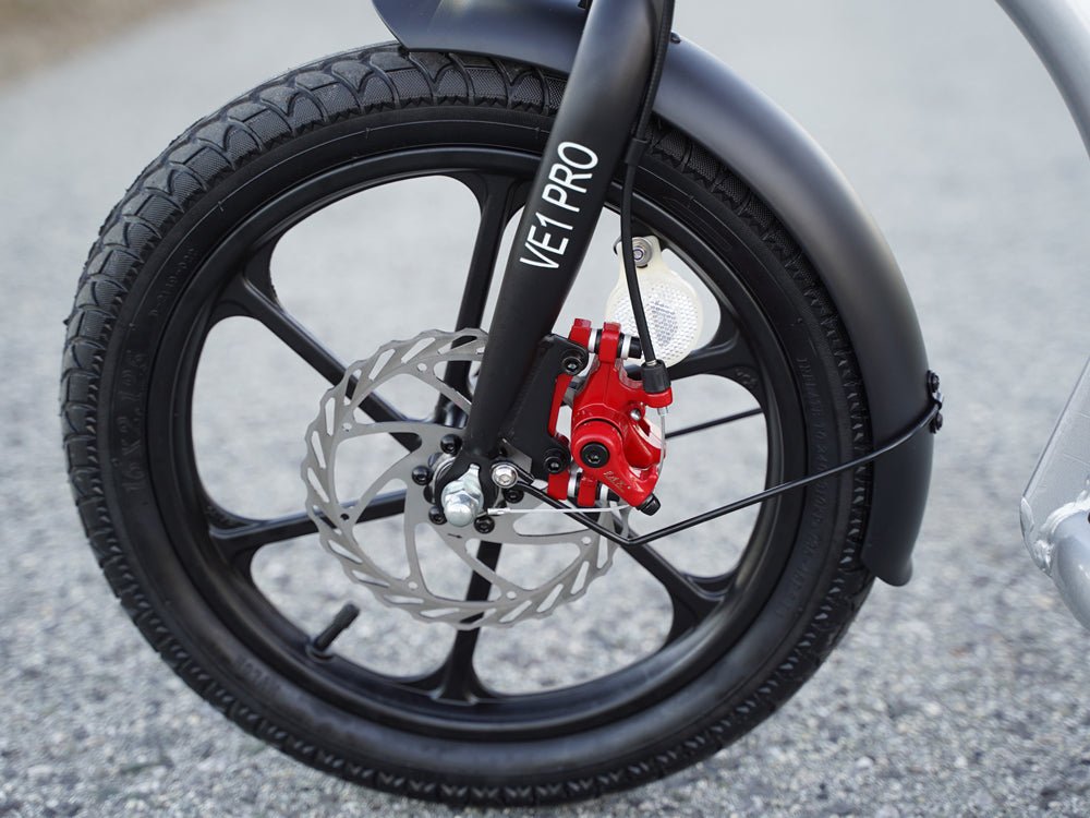 Front disc brake with red caliper and reflector on the Hiboy VE1 Pro electric scooter