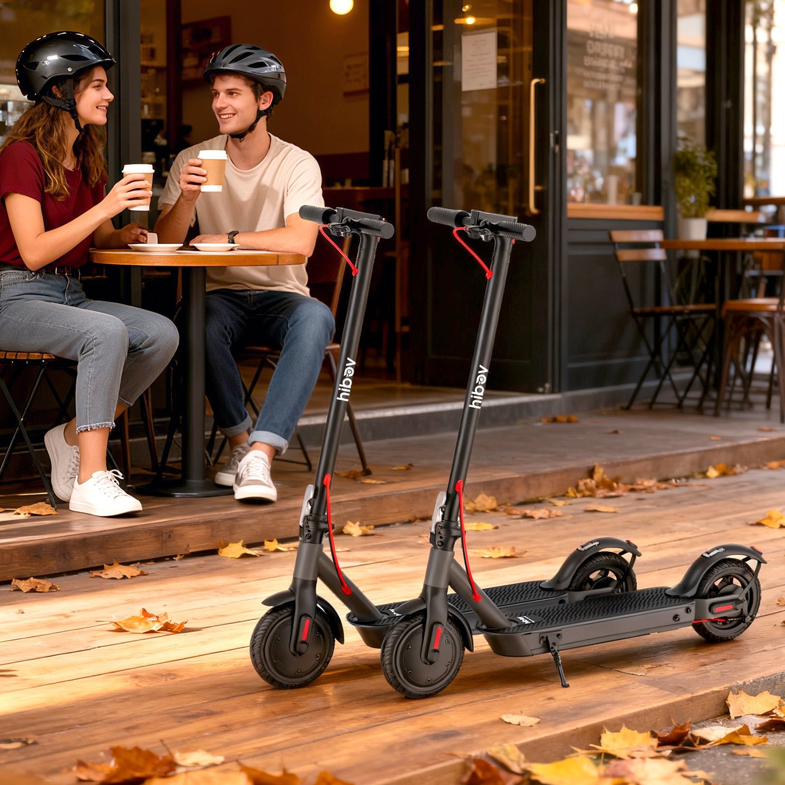 Two Hiboy S2 Nova electric scooters parked outside a cafe
