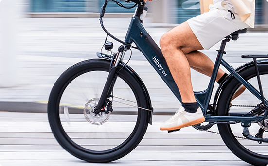 Rider pedaling a navy Hiboy EX9 electric bike, showing the slim 6061 aluminum frame