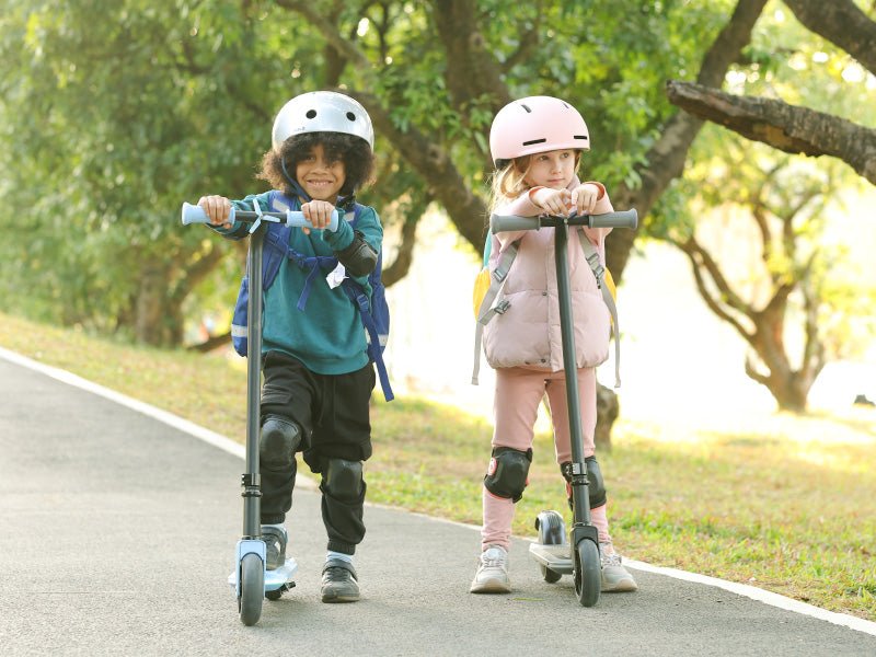 Two children pushing off on Hiboy ES1 kids electric scooters