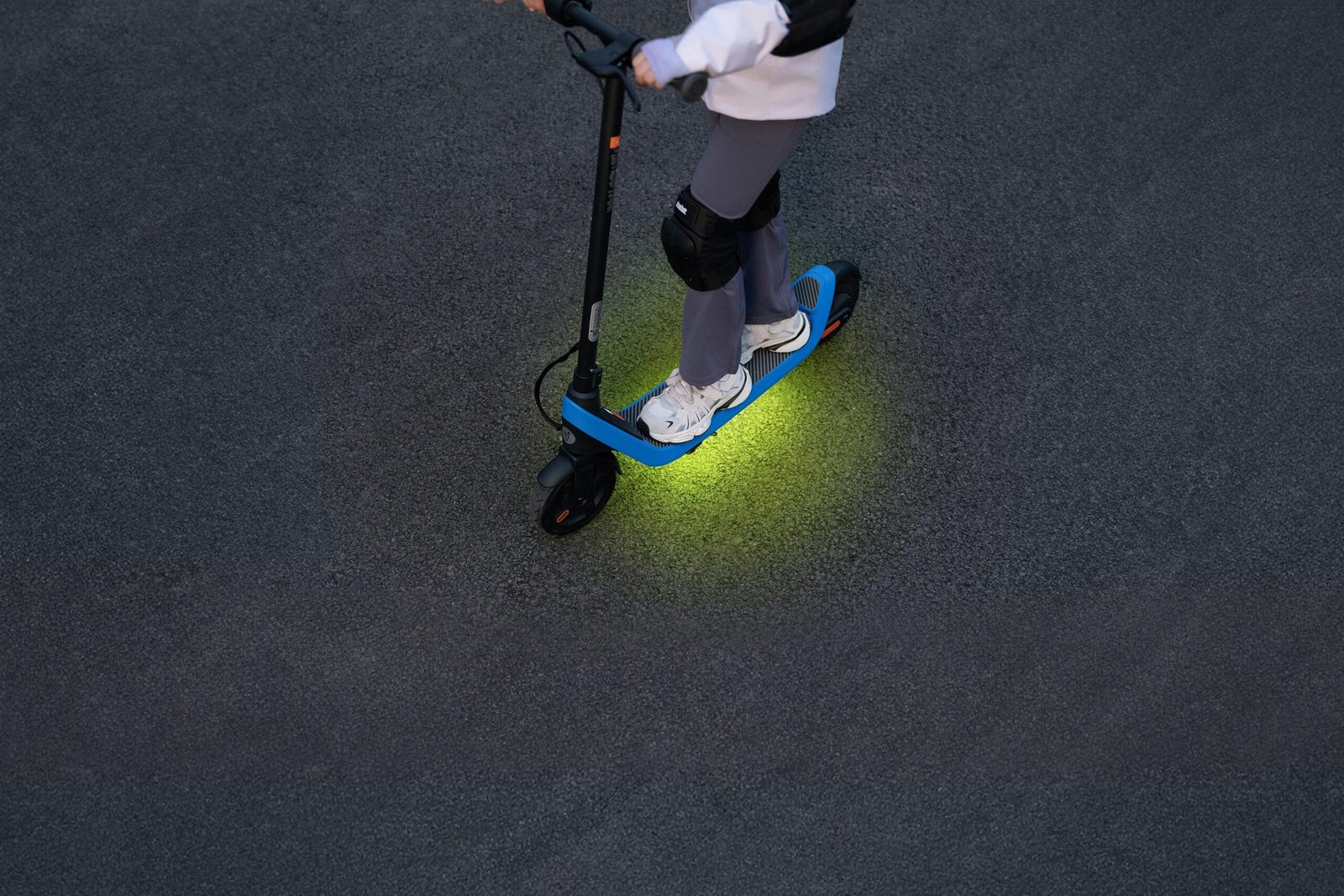 Segway Ninebot C2 Lite with the ambient light glowing under the footboard at night