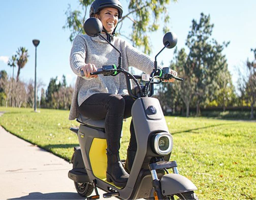 Rider seated on the Segway eMoped C80 in a park