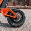 Close-up of the INMOTION RS Lite rear wheel, hub motor and orange swingarm