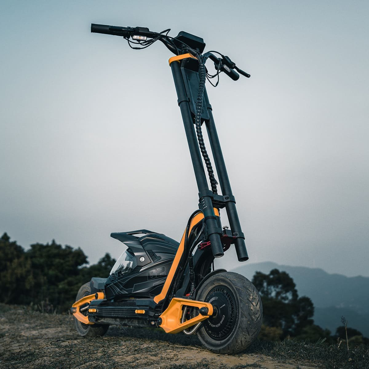 INMOTION RS electric scooter stood folded upright on a hillside at dusk