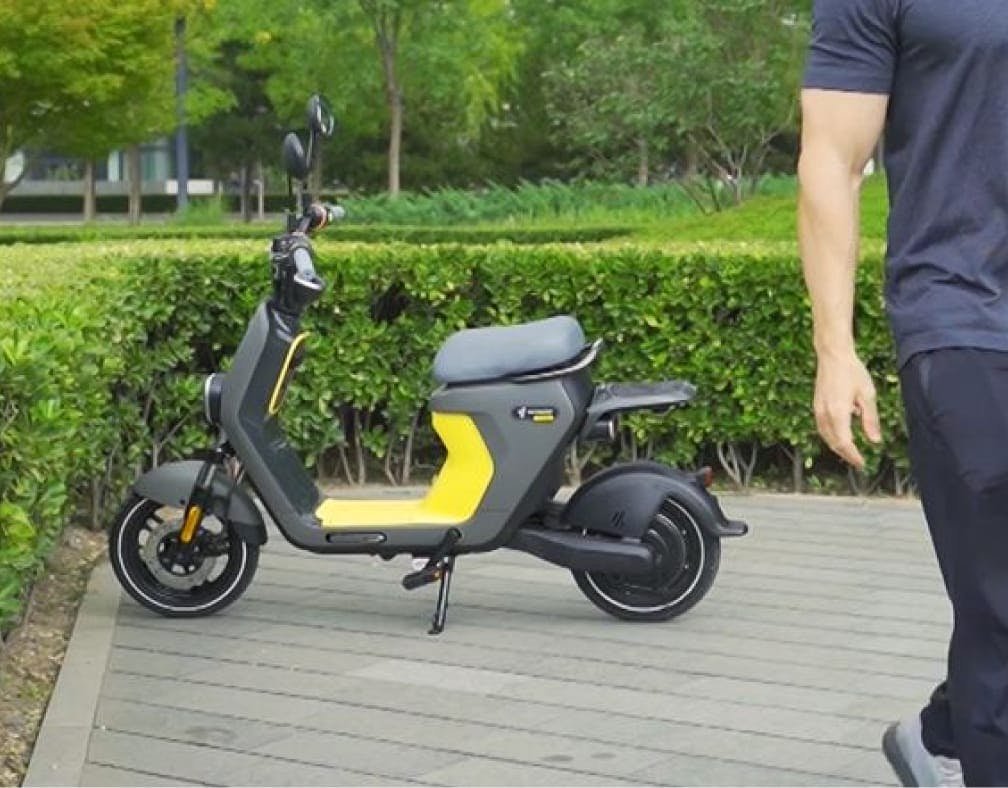 Rider walking away from the parked Segway eMoped C80