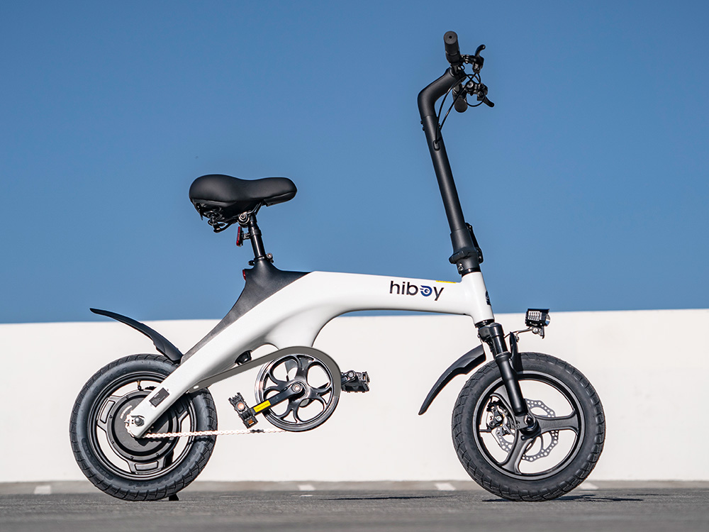 White Hiboy C1 folding electric bike in profile against a blue sky