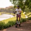 Rider on the Teverun Blade GT II electric scooter on a park path