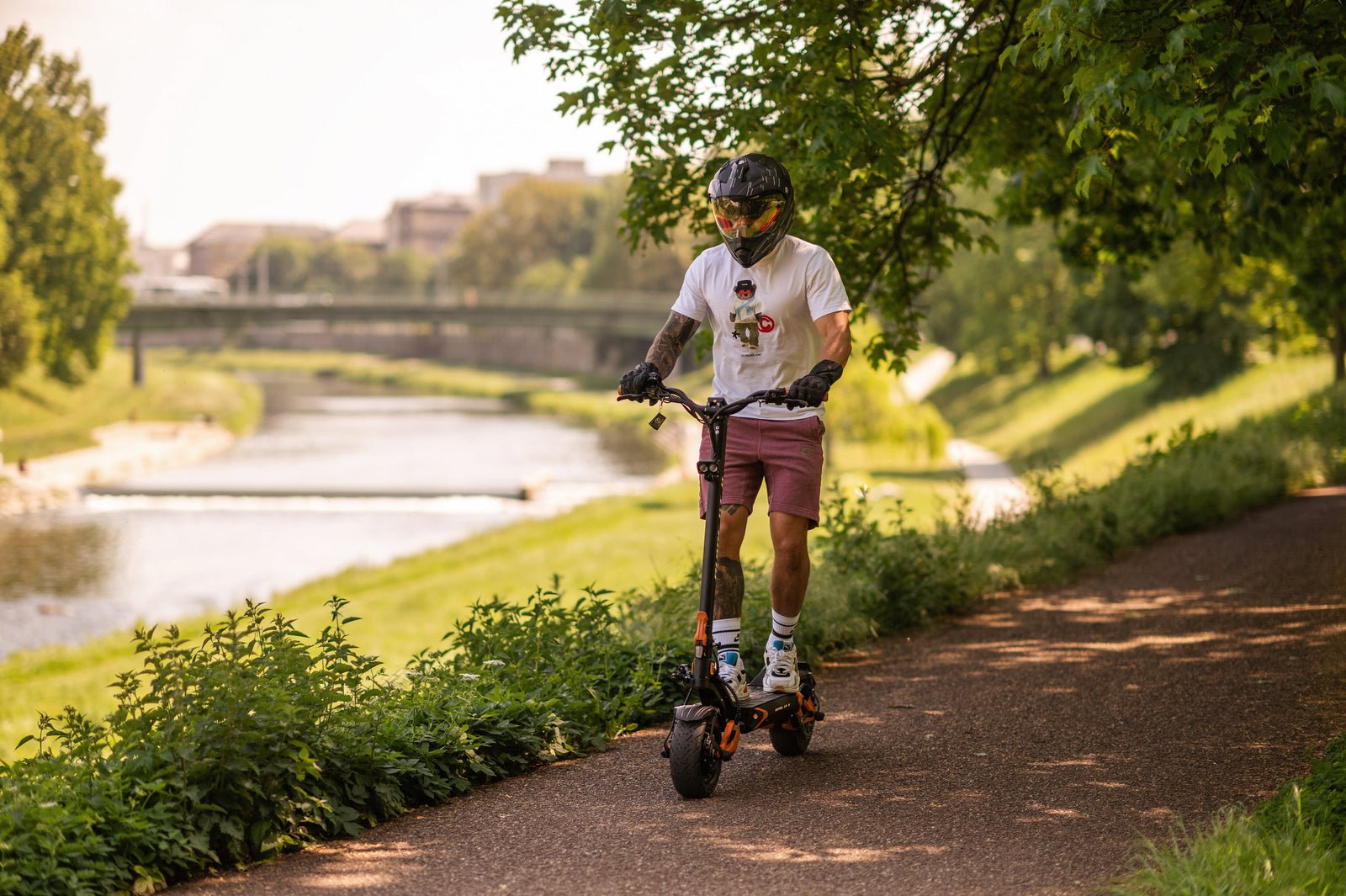 Rider on the Teverun Blade GT II electric scooter on a park path