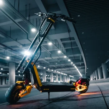 INMOTION RS electric scooter lit up at night under a concrete underpass