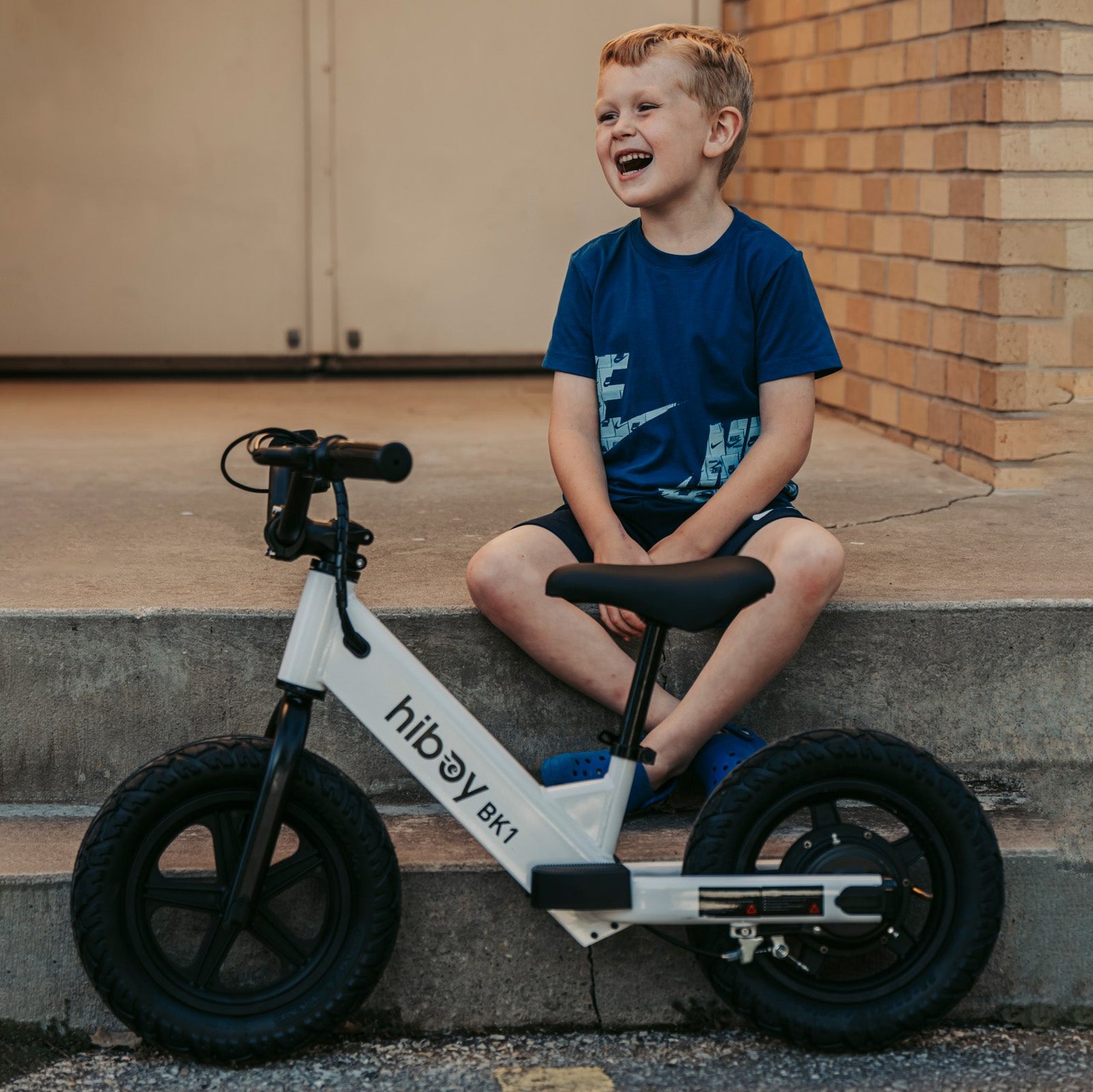 Child standing with the Hiboy BK1 electric balance bike