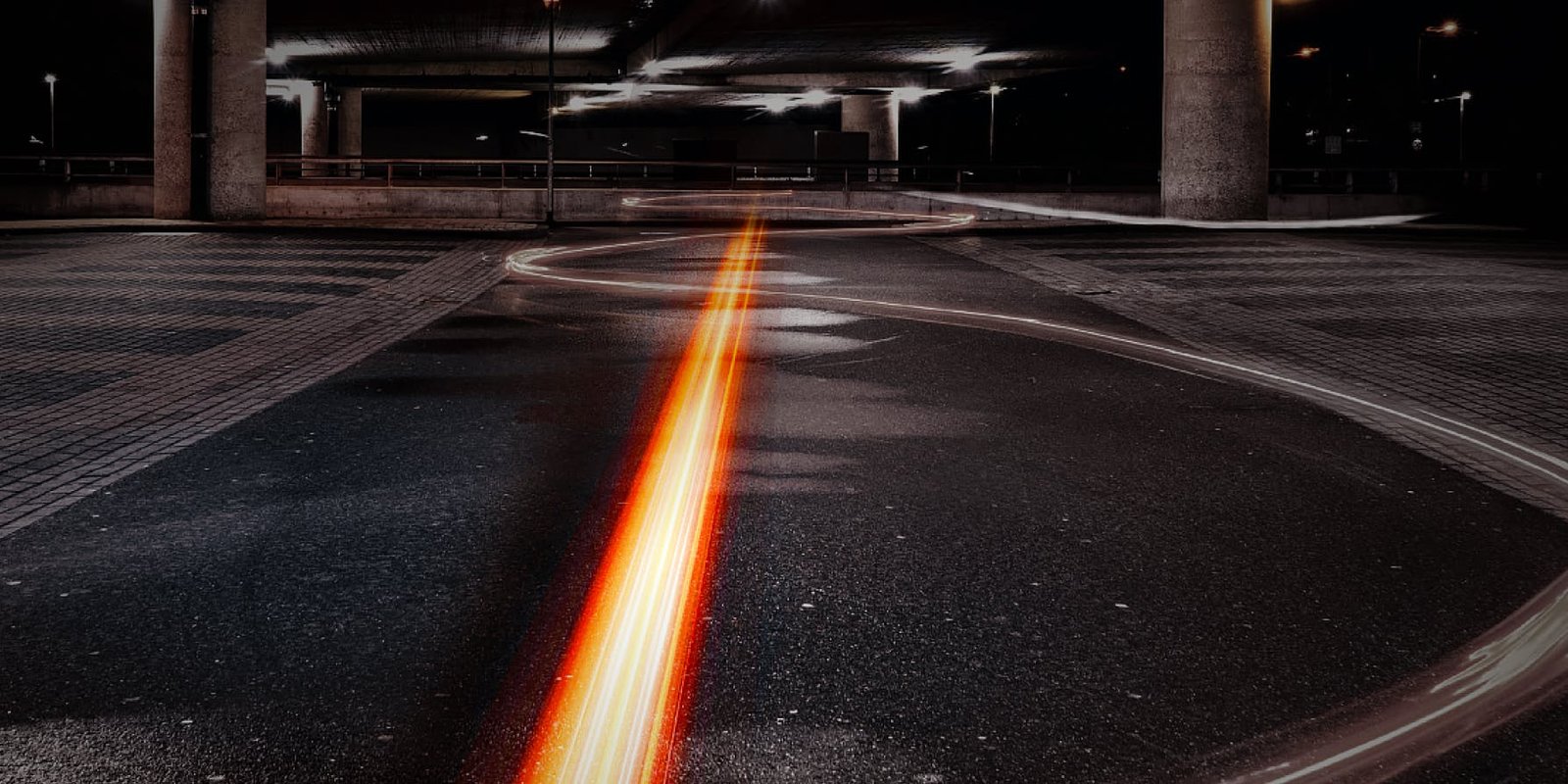 Light trail of the Segway GT3 SuperScooter cornering under a bridge at night