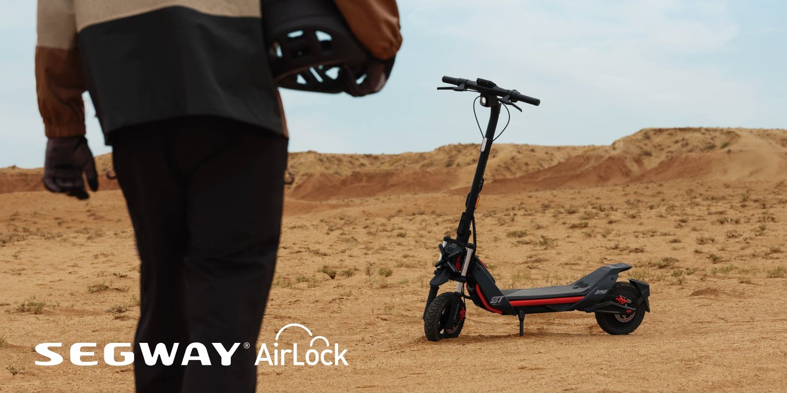 Rider walking toward the Segway ZT3 Pro electric scooter in the desert as Segway AirLock unlocks it