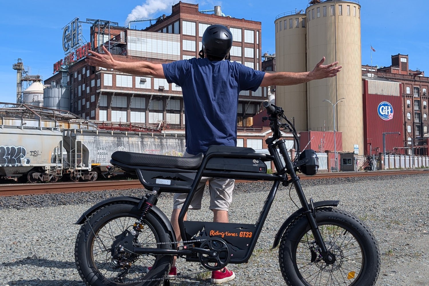 Riding’times GT33 cargo electric bike rider beside industrial silos