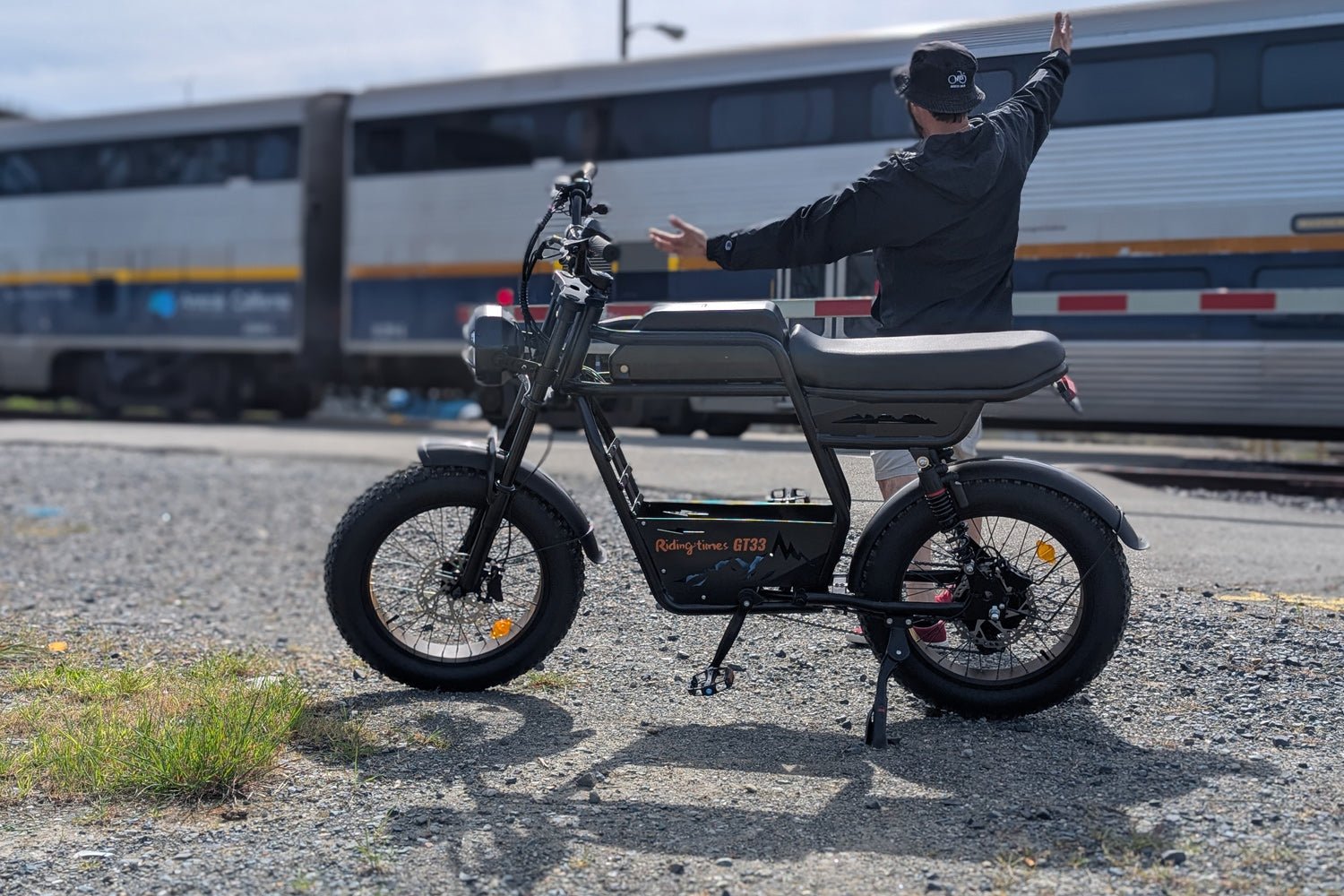 Riding’times GT33 cargo electric bike rider beside a passing train