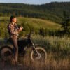 Rider standing beside the Riding’times GT73 Pro electric motorbike on a hillside at dusk