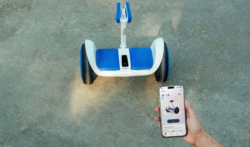 Segway app on a phone next to the Ninebot S2 Kids