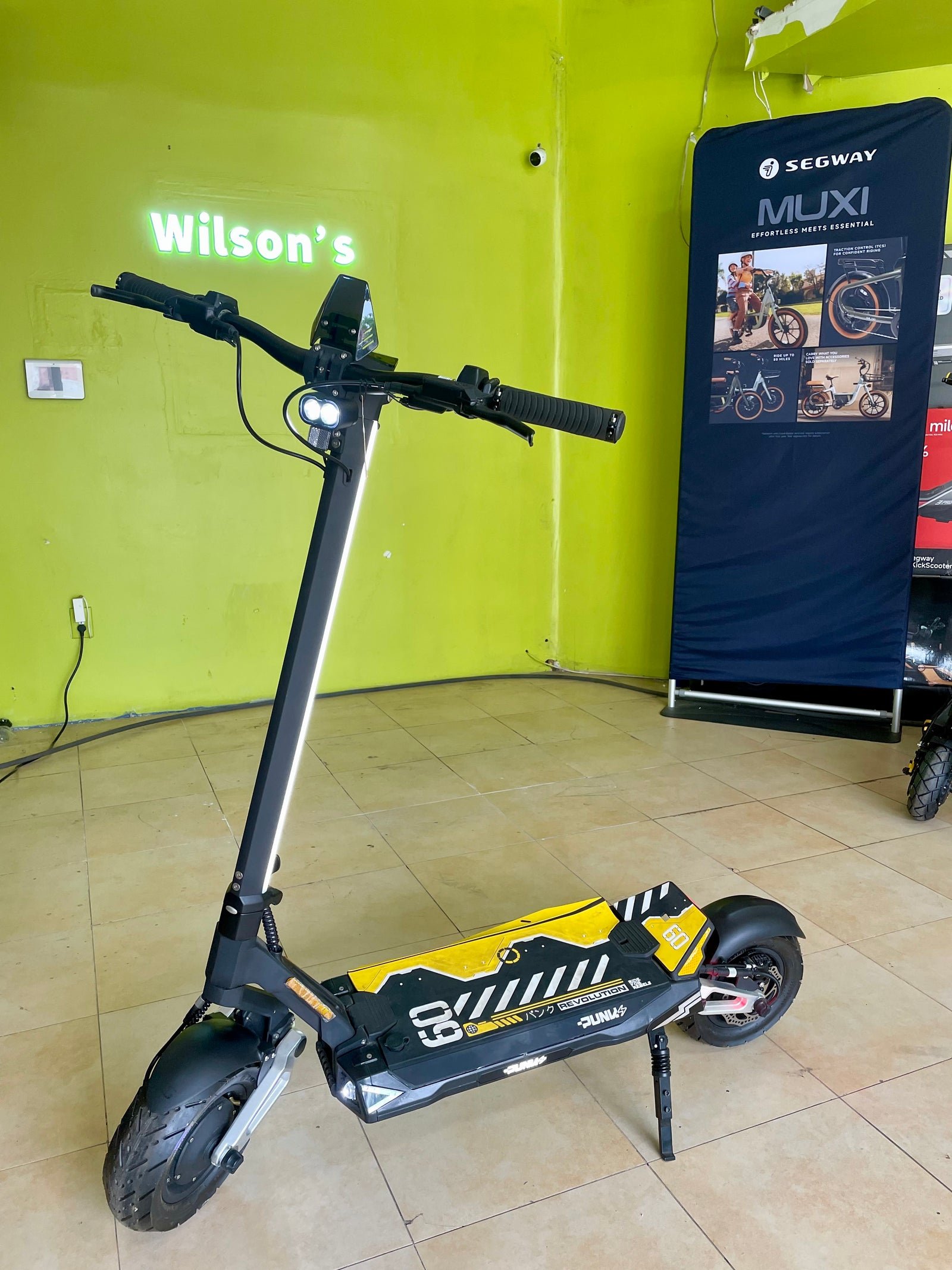 Punk Rebel electric scooter on the floor of a Wilson’s shop