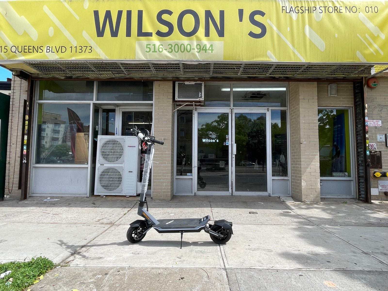 Punk Rider electric scooter parked outside a Wilson’s shop