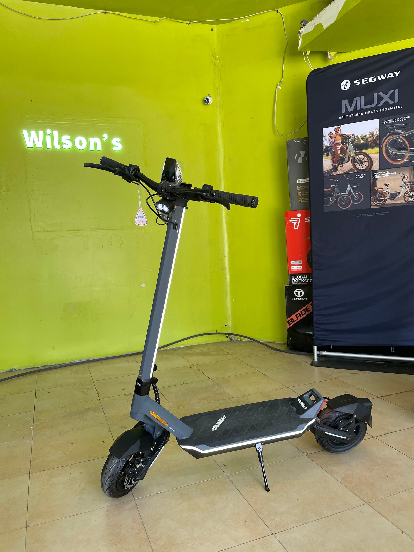 Punk Rider electric scooter inside a Wilson’s shop, seen from the front quarter