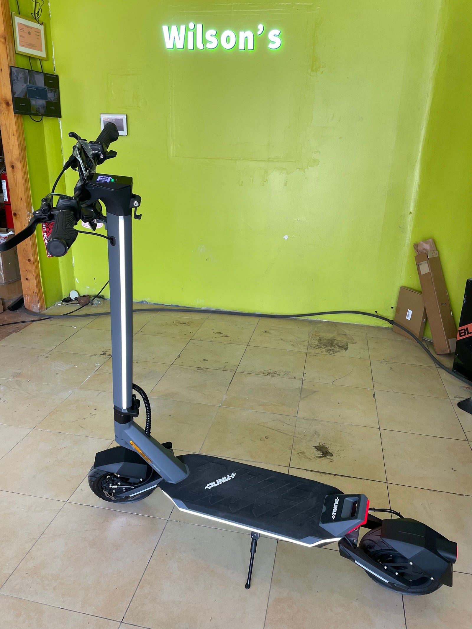 Punk Rider Pro electric scooter on the floor of a Wilson’s shop