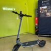 Punk Rider Pro electric scooter inside a Wilson’s shop, seen from the front quarter