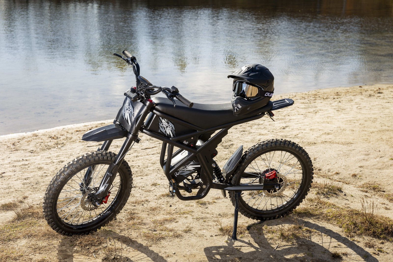 Riding’times GT73 electric motorbike parked beside a river