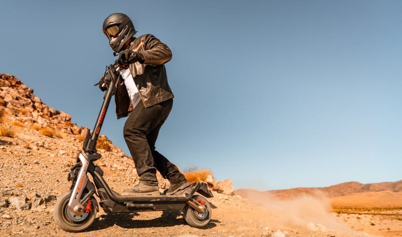 Rider braking hard on the Segway GT3 Pro SuperScooter on a desert road
