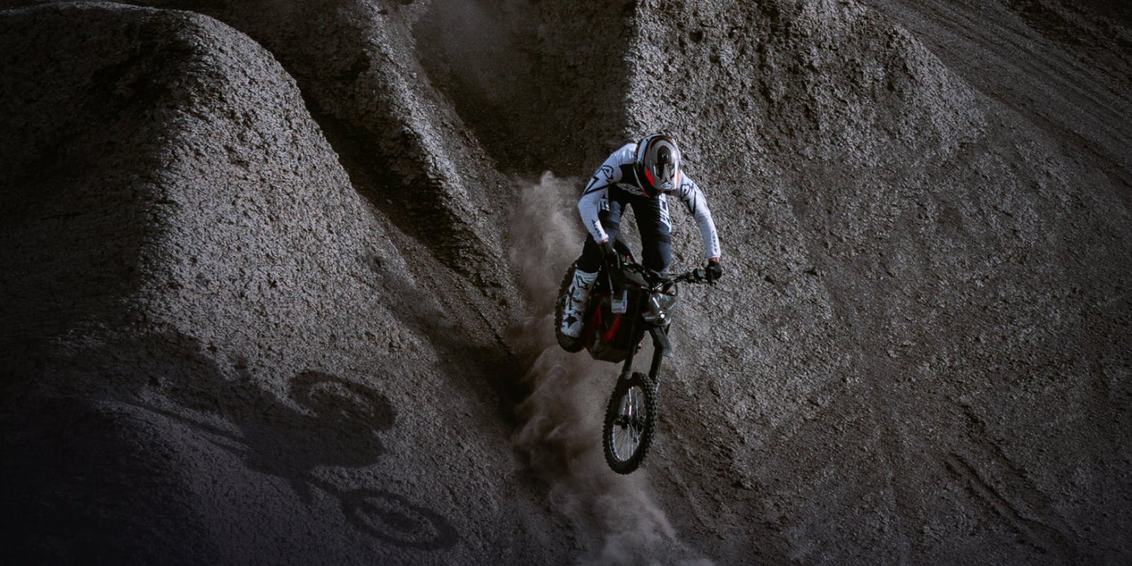 Rider on the Segway Xaber 300 electric dirt bike carving a dirt slope
