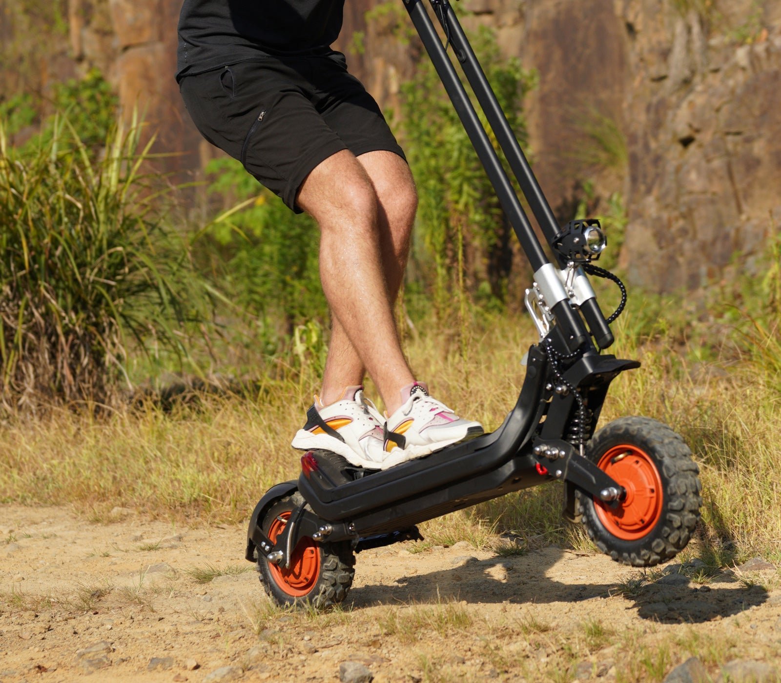 Rider stepping onto the Riding’times G63 dual motor electric scooter on a trail