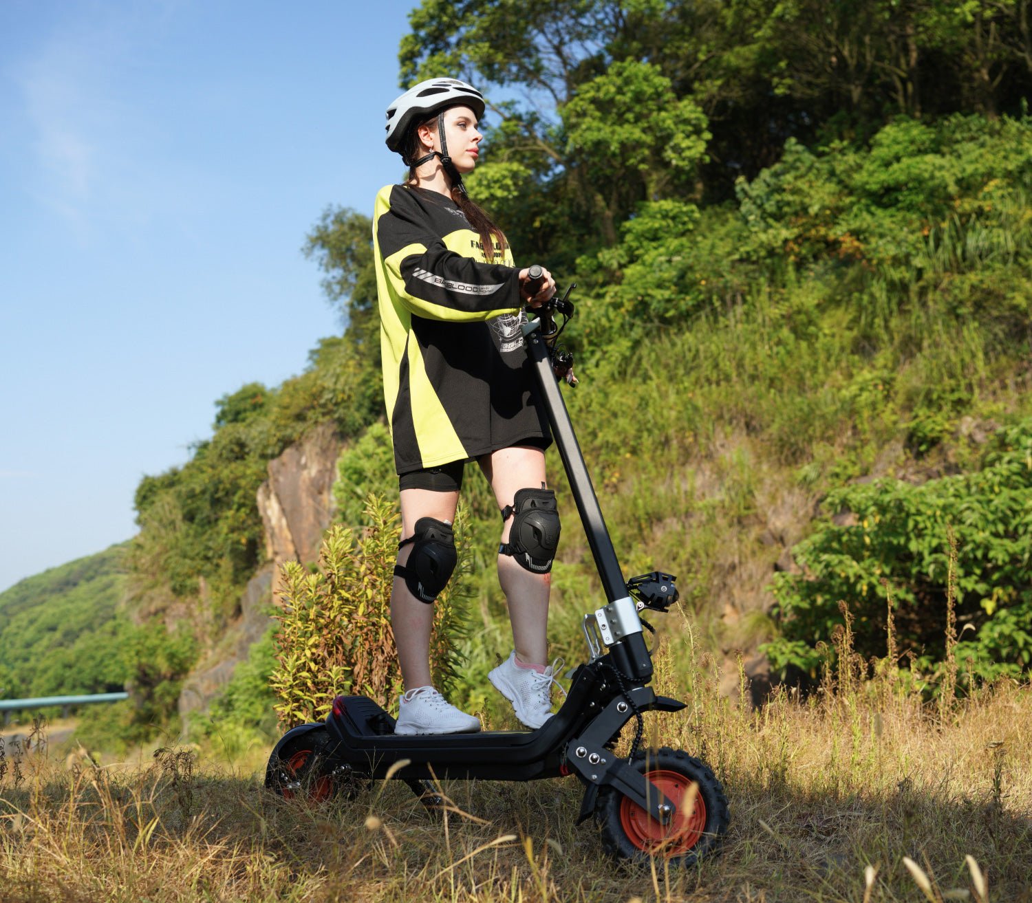 Rider on the Riding’times G63 dual motor electric scooter on a hillside