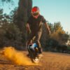 Rider throwing up dust on an INMOTION V14 PRO electric unicycle at sunset