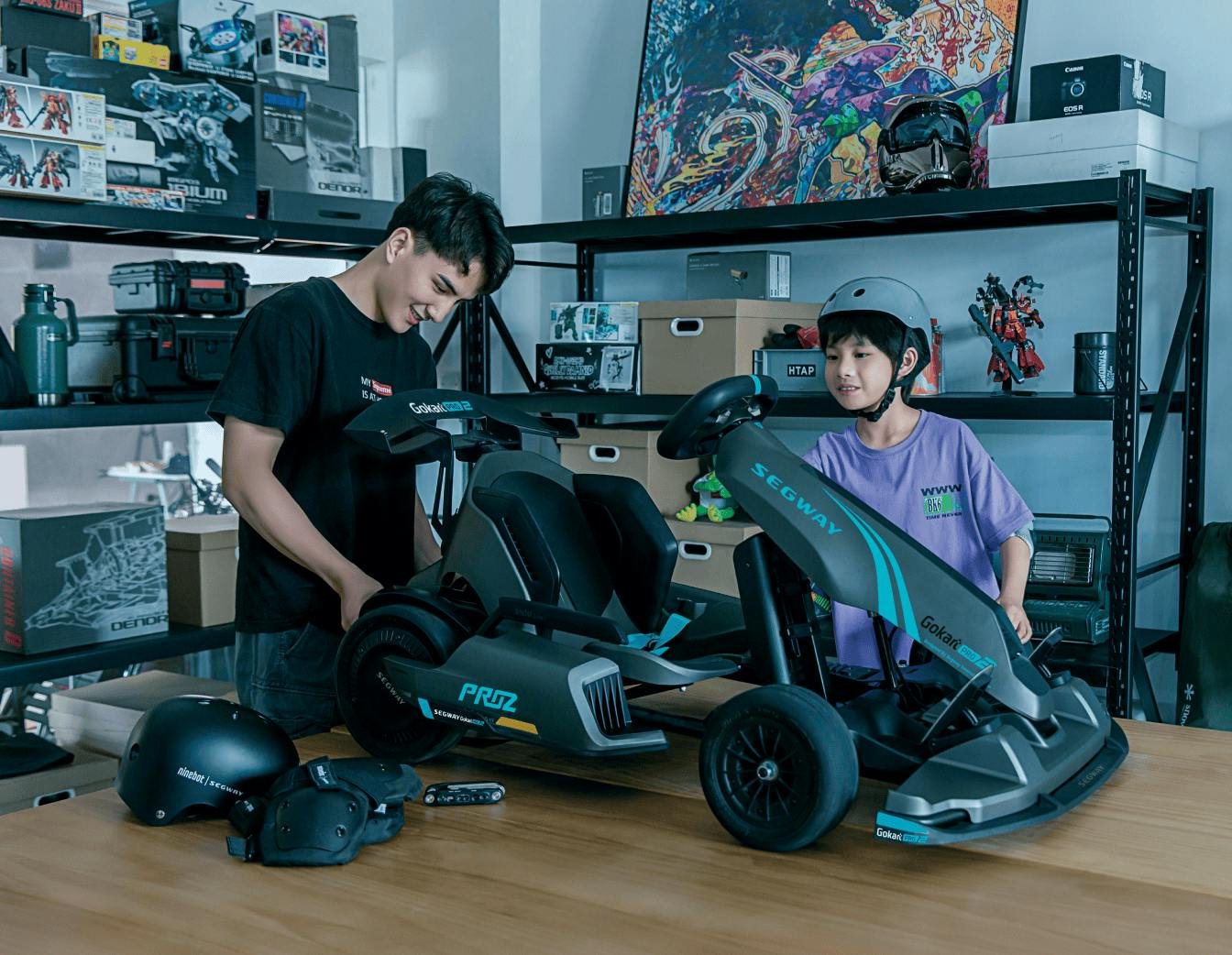 Two people building the Segway GoKart Pro 2 in a garage