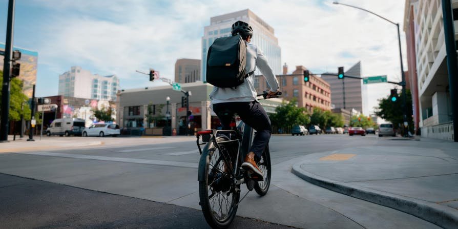 Rider starting from a city intersection on the Segway Myon electric bike