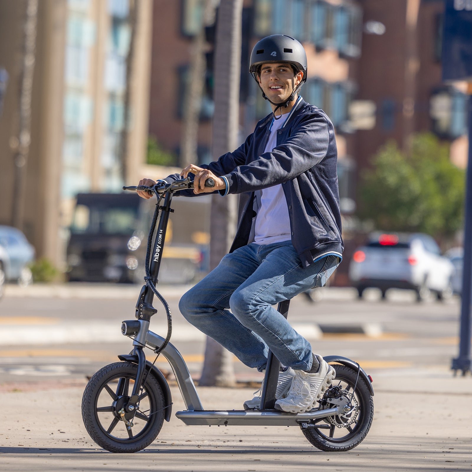 Rider seated on the Hiboy ECOM 14 electric scooter on a city street